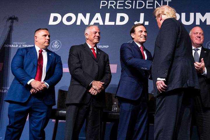 Former President Donald Trump, right, shakes hand with former Nevada Attorney General Adam Laxa ...