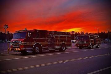 Las Vegas Fire Department crews leave nearly three weeks in the Los Angeles area as the sun set ...