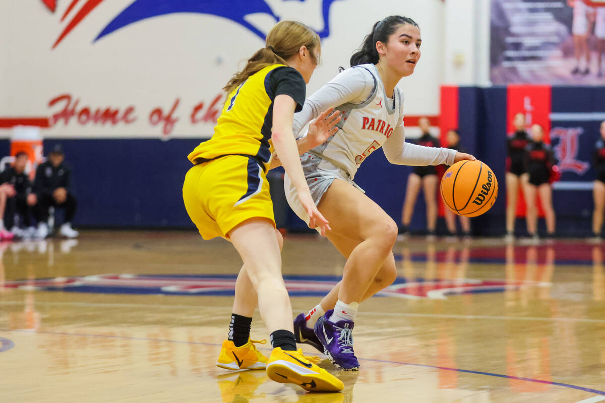 Liberty guard Samantha Chesnut (5) dribbles the ball during a girls basketball game between Dem ...