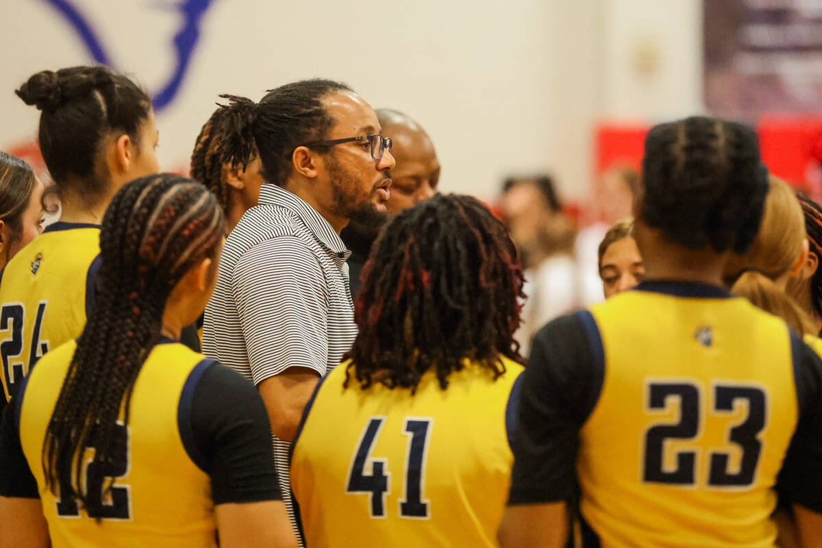 Democracy Prep head coach Julius Barren coaches his team during a time out during a girls baske ...