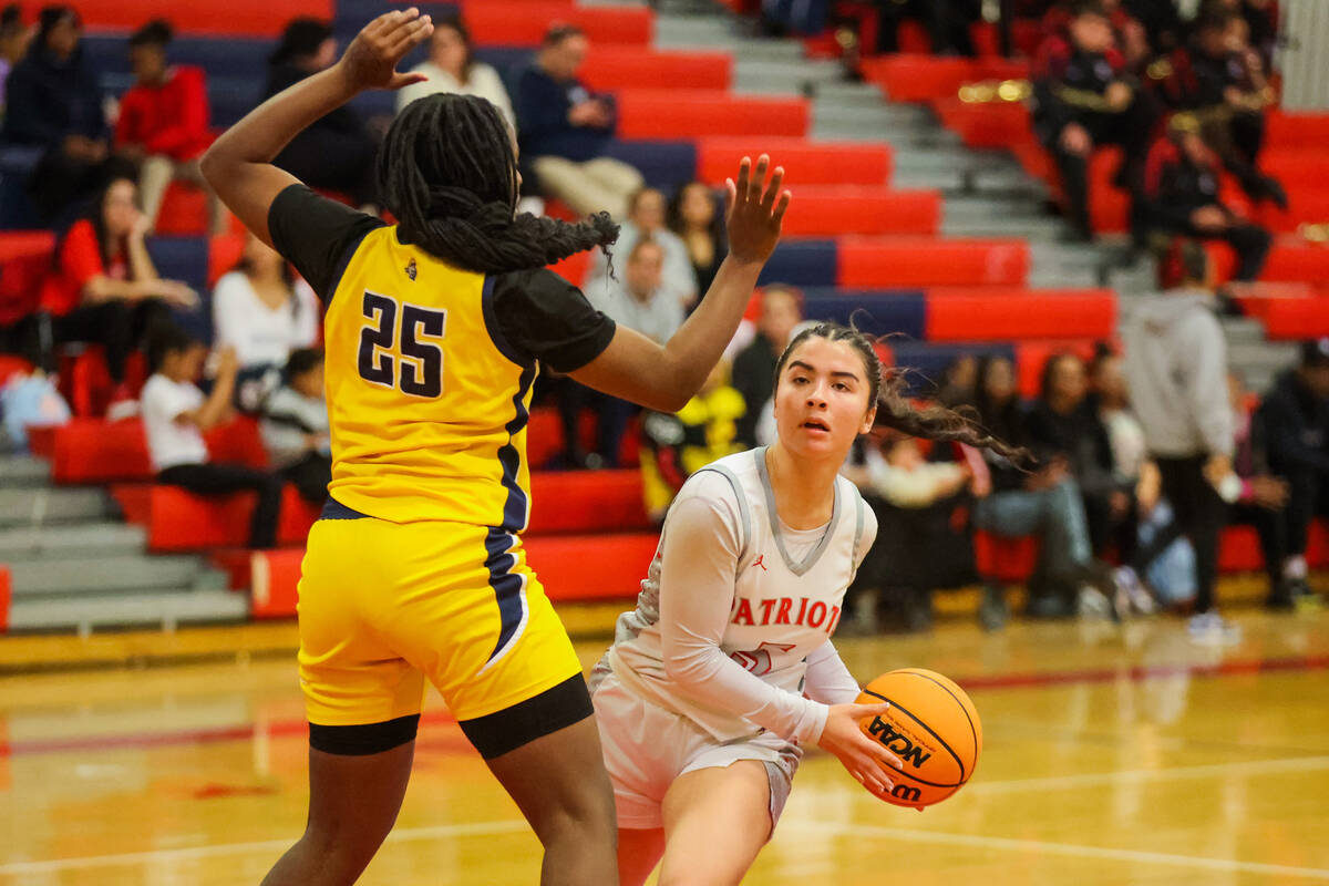 Liberty guard Samantha Chesnut (5) eyes an open teammate as Democracy Prep guard ZhaNea Burrell ...