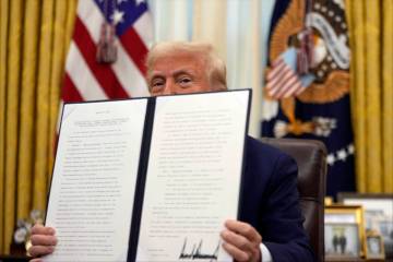 President Donald Trump holds a signed an executive order regarding the declassification and rel ...