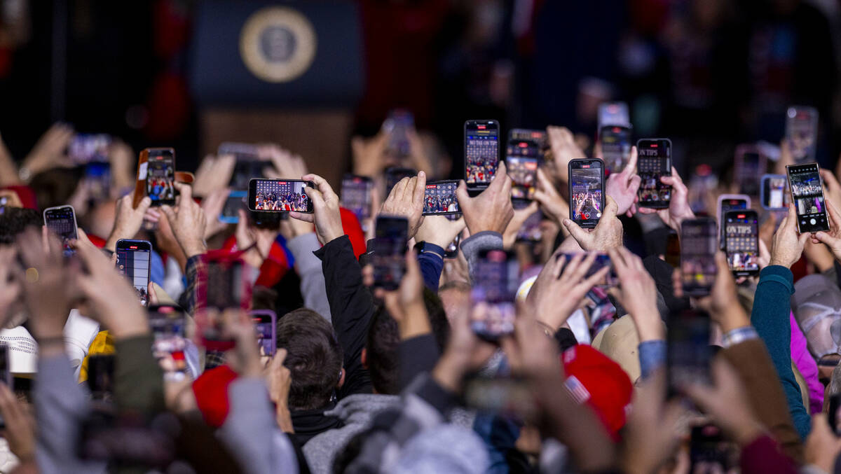 Phones are raised to take photos and videos as President Donald Trump arrives to speak to suppo ...