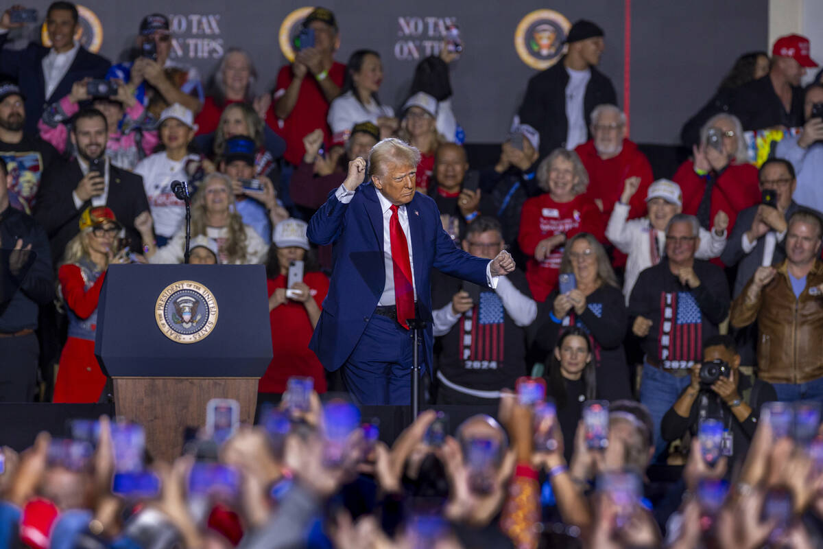 President Donald Trump dances with supporters after a speech at the Circa on Saturday, Jan. 25, ...