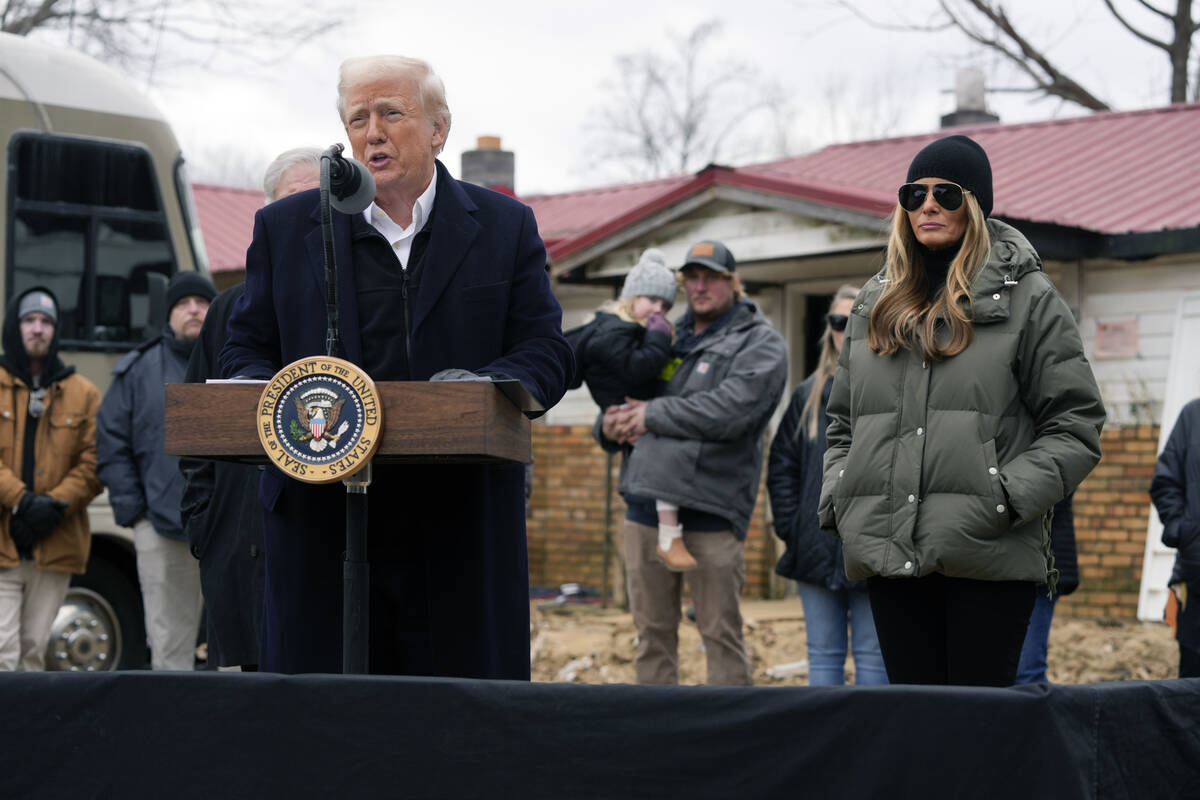 President Donald Trump speaks along side first lady Melania Trump, as they meet with homeowners ...