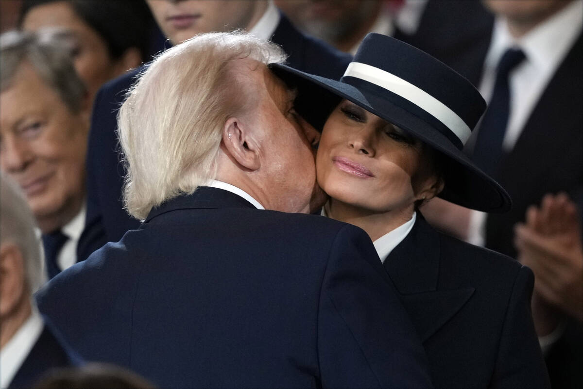 President Donald Trump kisses first lady Melania Trump during the 60th Presidential Inauguratio ...