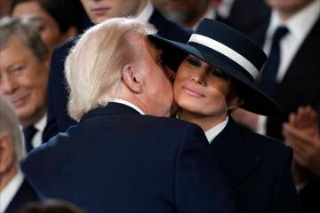 President Donald Trump kisses first lady Melania Trump during the 60th Presidential Inauguratio ...