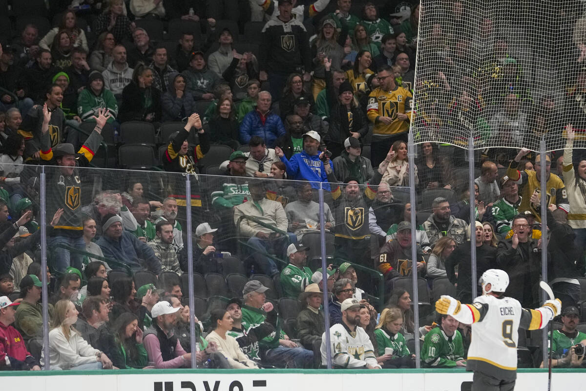 Vegas Golden Knights center Jack Eichel, right, reacts toward supporters after scoring a goal a ...