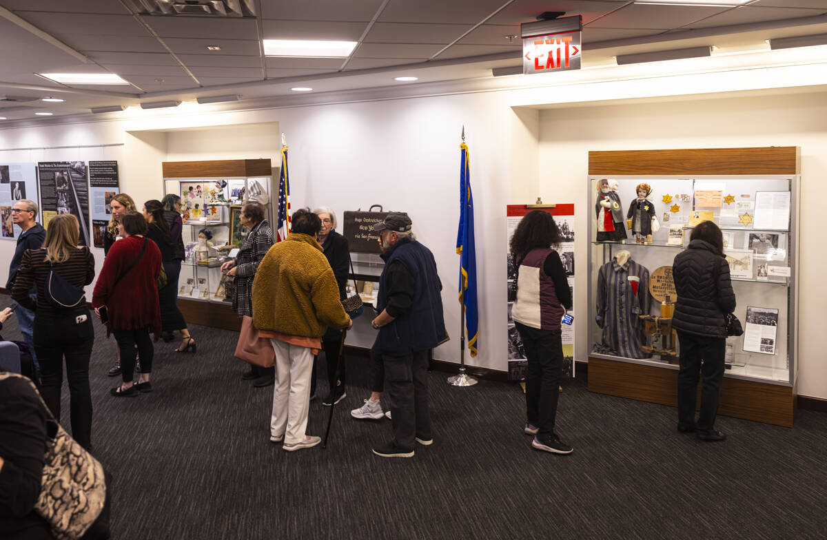 Visitors explore the "The Holocaust: Reconstructing Shattered Humanity" exhibit curat ...