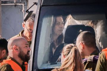 Israeli soldier Karina Ariev, who was kidnapped in Gaza by Hamas on Oct. 7, gets on a bus after ...