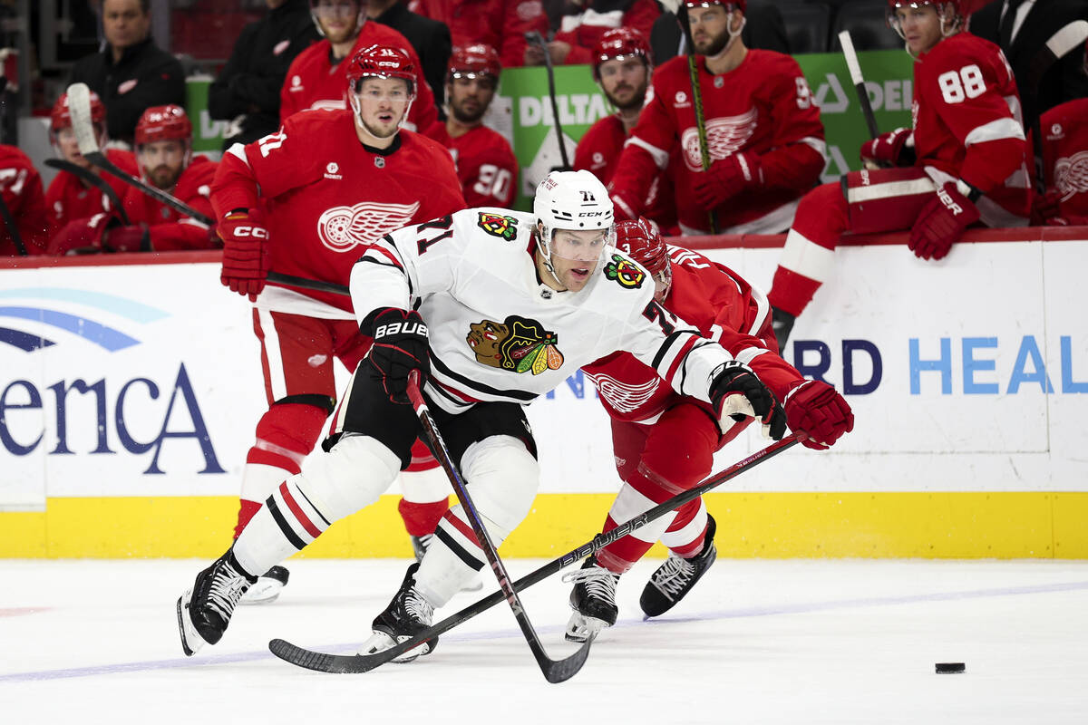 Chicago Blackhawks forward Taylor Hall (71) skates the puck by Detroit Red Wings defenseman Jus ...