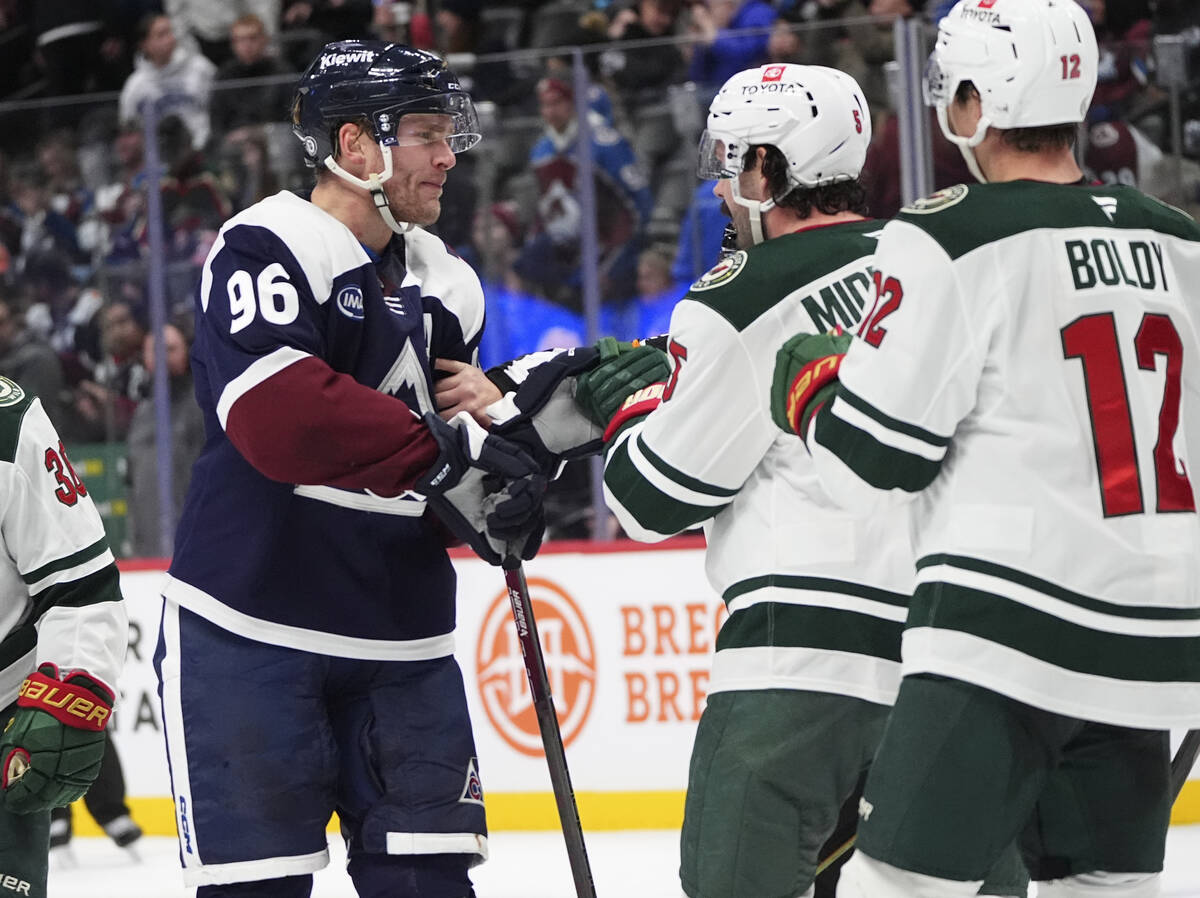 Colorado Avalanche right wing Mikko Rantanen, left, squares off against Minnesota Wild defensem ...