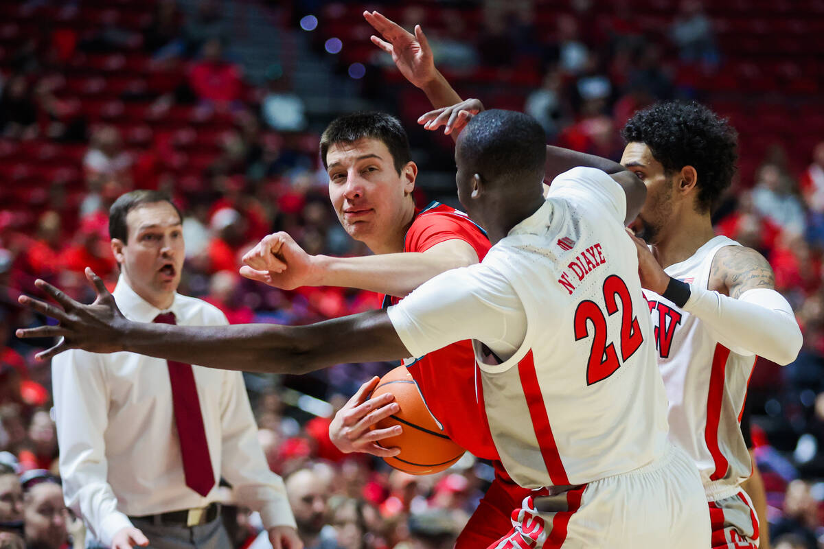 New Mexico Lobos forward Filip Borovicanin (8) finds himself trapped in Rebels defense during a ...