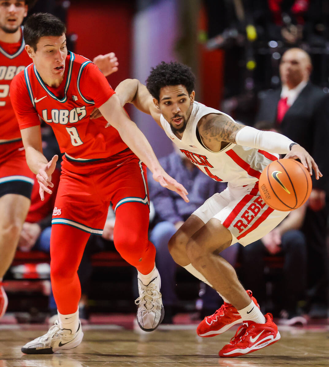 Rebels guard Jailen Bedford (14) lunges for the ball as he loses his grip on it while New Mexic ...