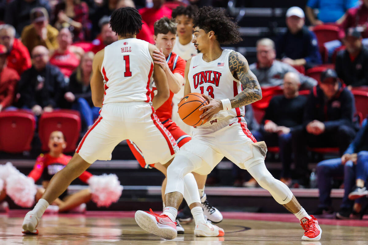 Rebels guard Brooklyn Hicks (13) drives the ball during an NCAA basketball game between the Reb ...