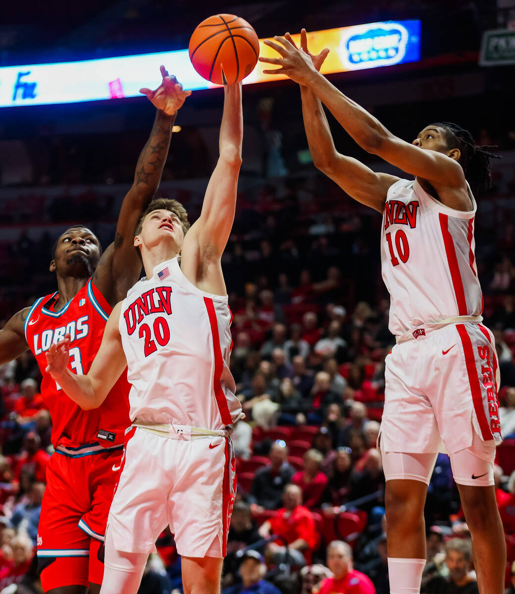 Rebels guard Julian Rishwain (20), Rebels guard Jaden Henley (10) and New Mexico Lobos forward ...