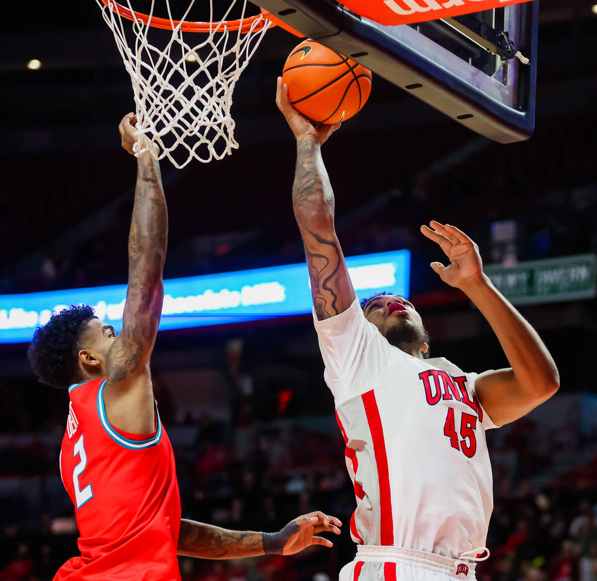 Rebels forward Jeremiah Cherry (45) goes up for a layup during an NCAA basketball game between ...