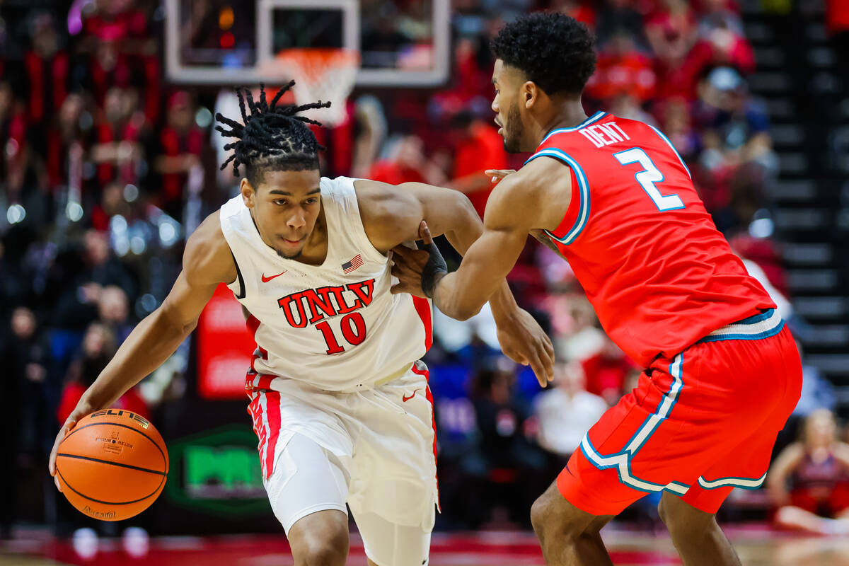 Rebels guard Jaden Henley (10) drives past New Mexico Lobos guard Donovan Dent (2) during an NC ...