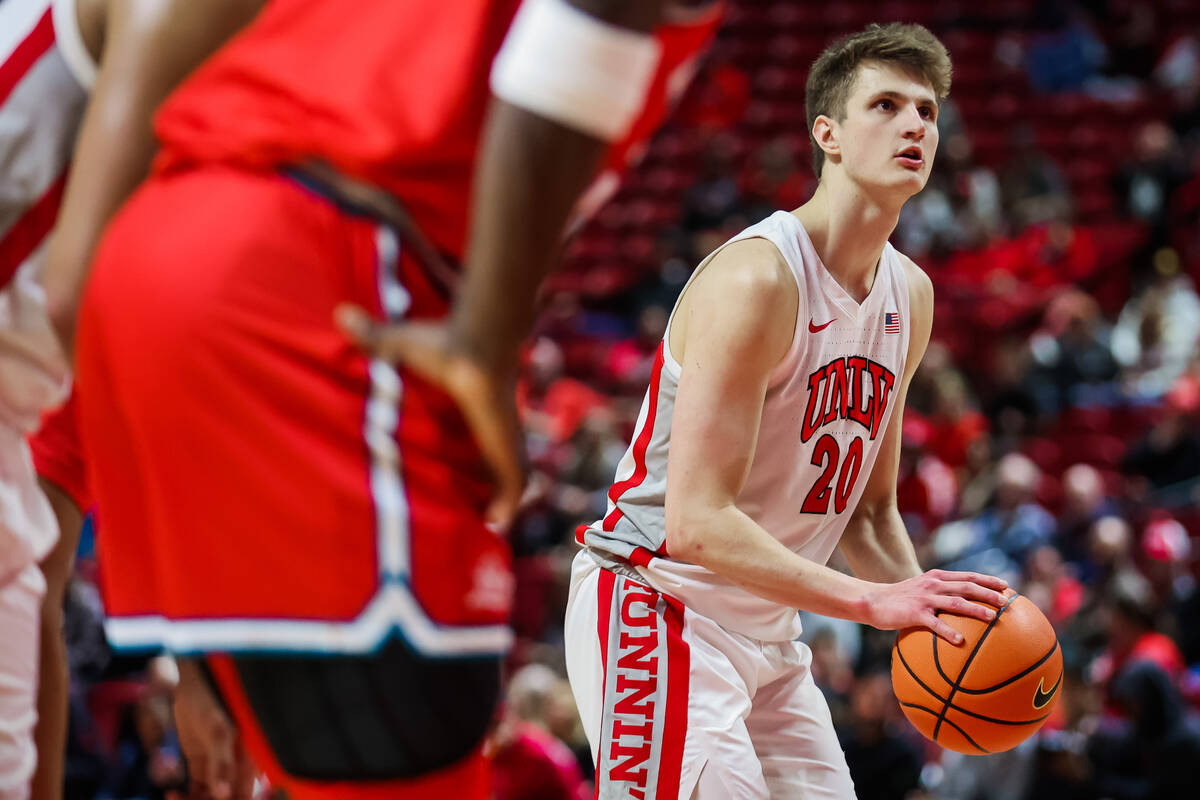 Rebels guard Julian Rishwain (20) attempts a free throw during an NCAA basketball game between ...