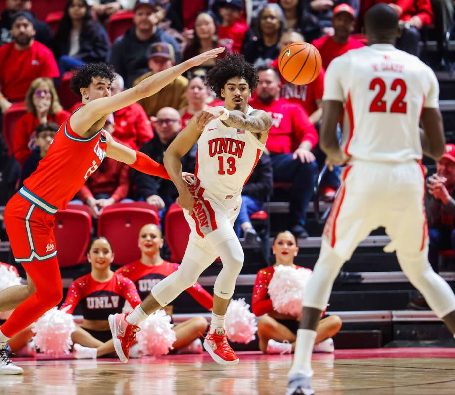 Rebels guard Brooklyn Hicks (13) passes the ball to Rebels forward Pape N'Diaye (22) during an ...