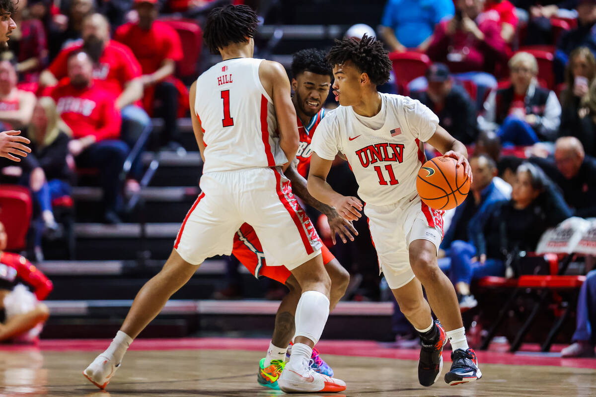 Rebels guard Dedan Thomas Jr. (11) dribbles the ball during an NCAA basketball game between the ...