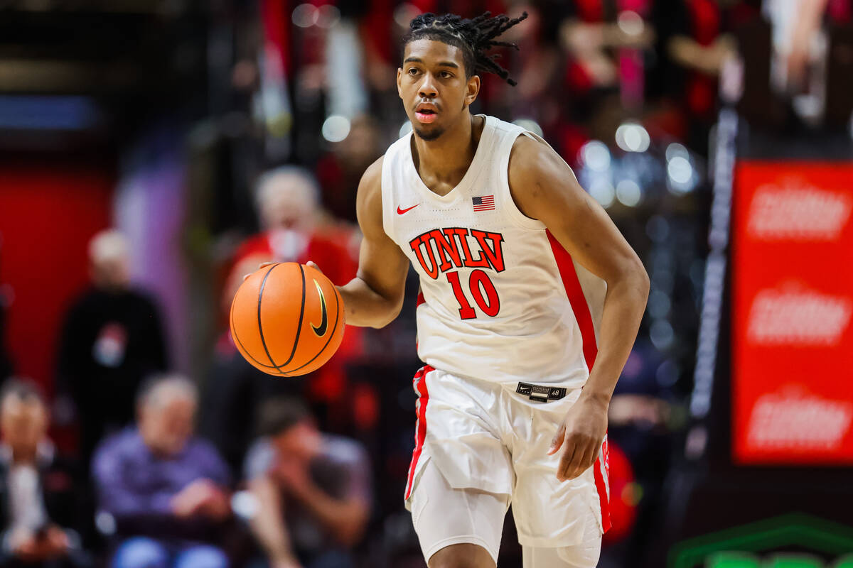 Rebels guard Jaden Henley dribbles the ball during an NCAA basketball game between the Rebels a ...