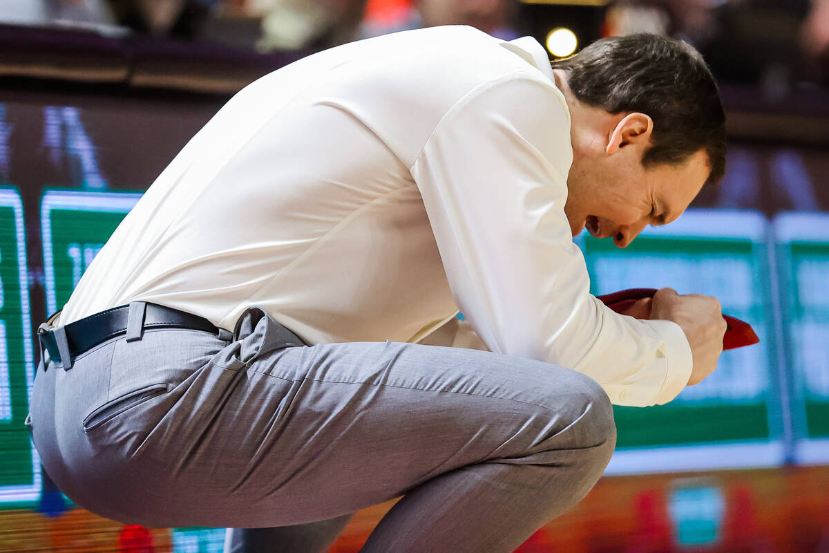 Rebels head coach Kevin Krueger reacts to a missed shot on the sidelines during an NCAA basketb ...