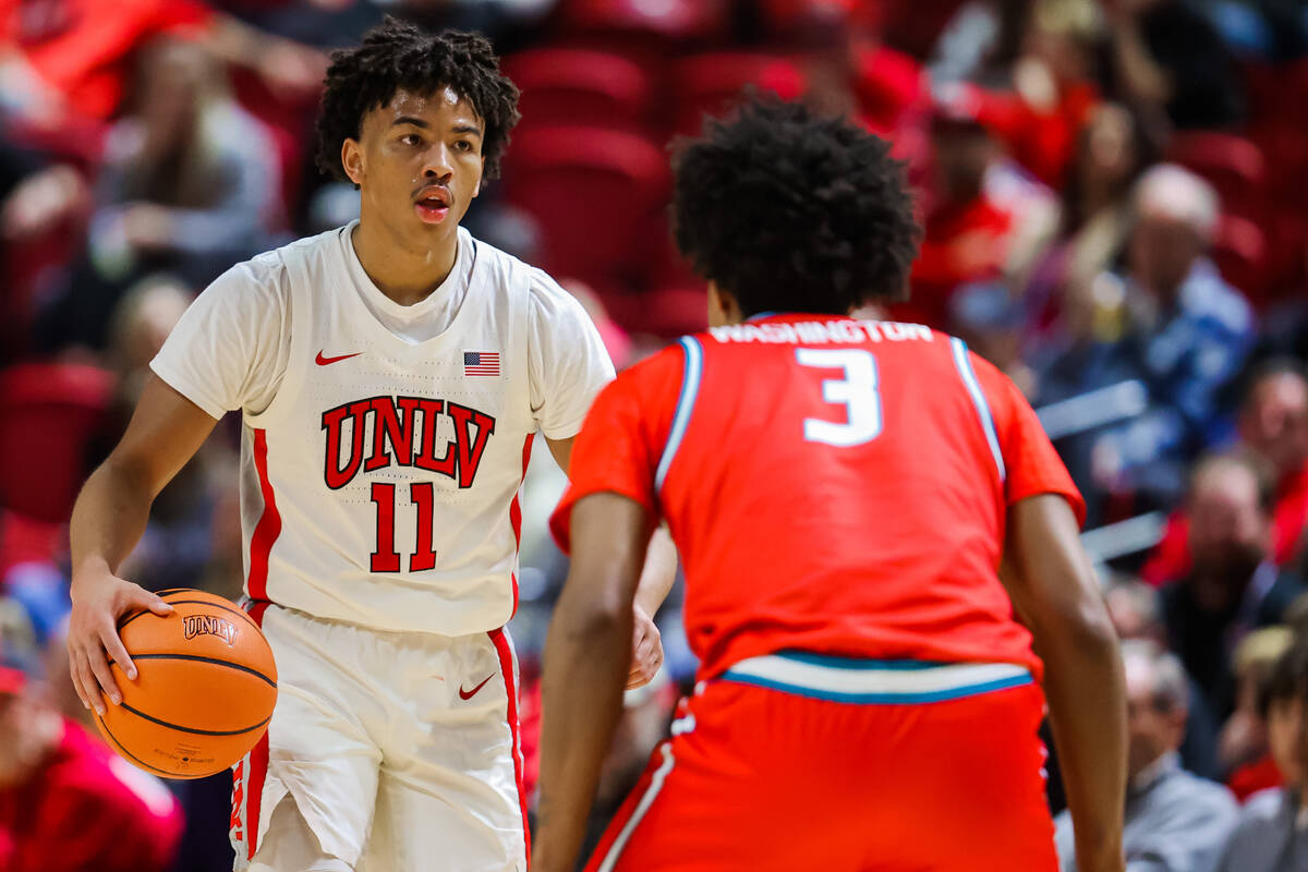 Rebels guard Dedan Thomas Jr. (11) dribbles the ball during an NCAA basketball game between the ...