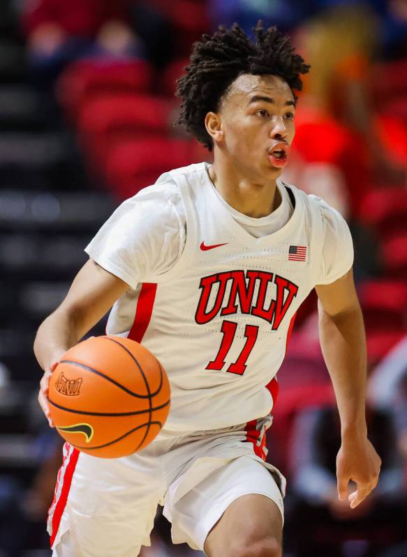 Rebels guard Dedan Thomas Jr. dribbles the ball during an NCAA basketball game between the Rebe ...