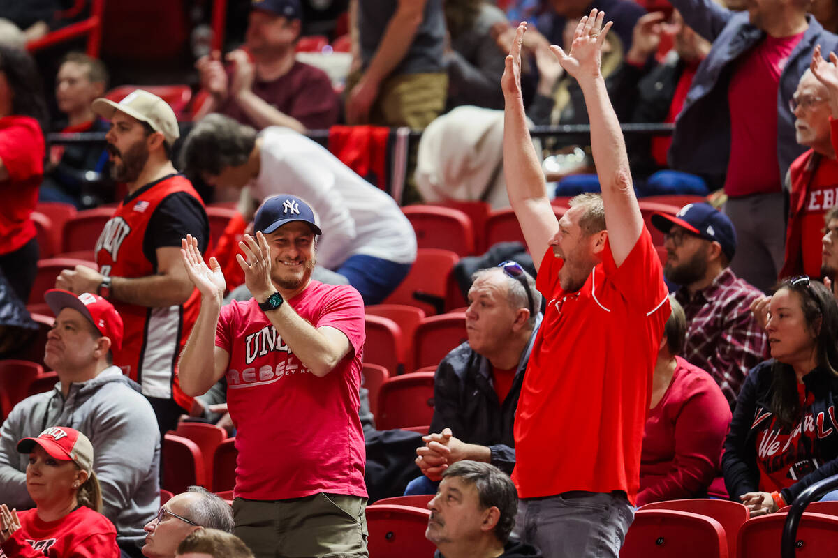 Rebels fans celebrate a temporary hot streak by the Rebels during an NCAA basketball game betwe ...