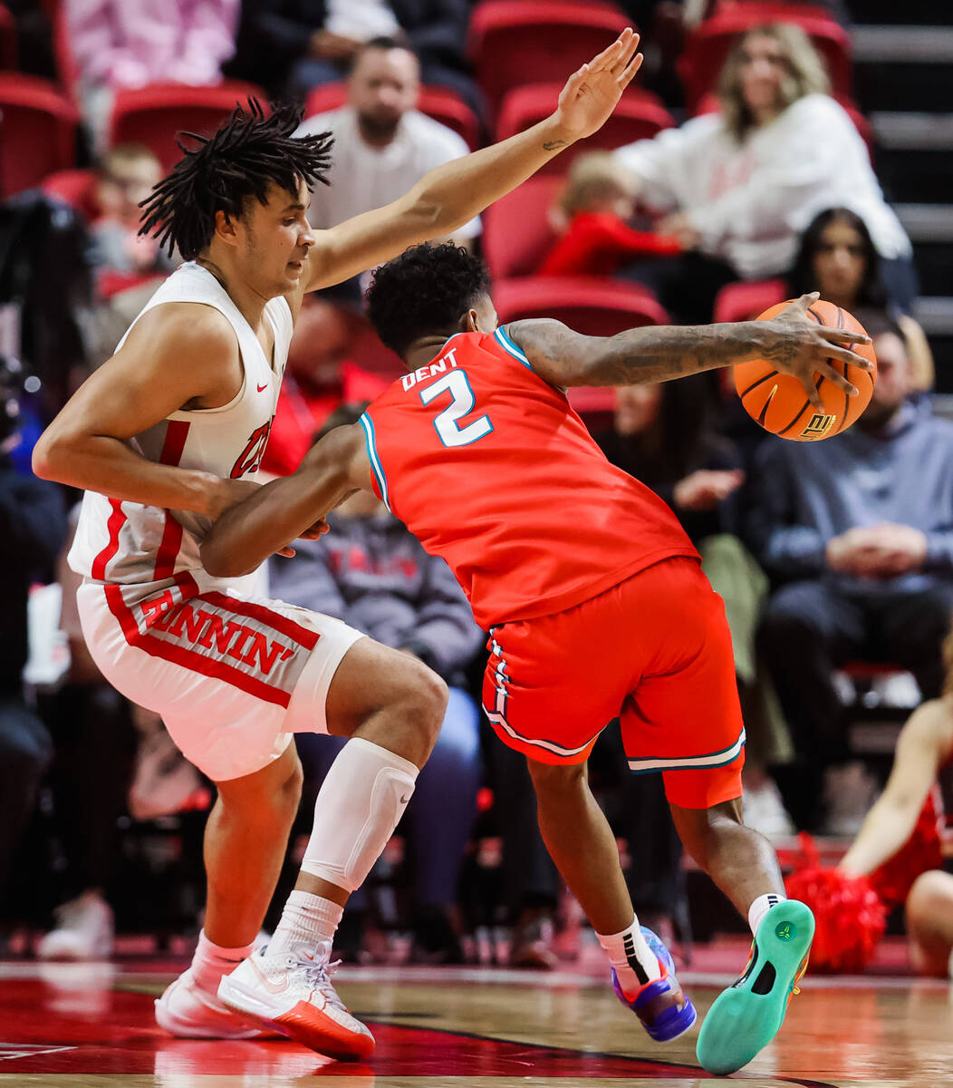 Rebels forward Jalen Hill (1) guards New Mexico Lobos guard Donovan Dent (2) during an NCAA bas ...