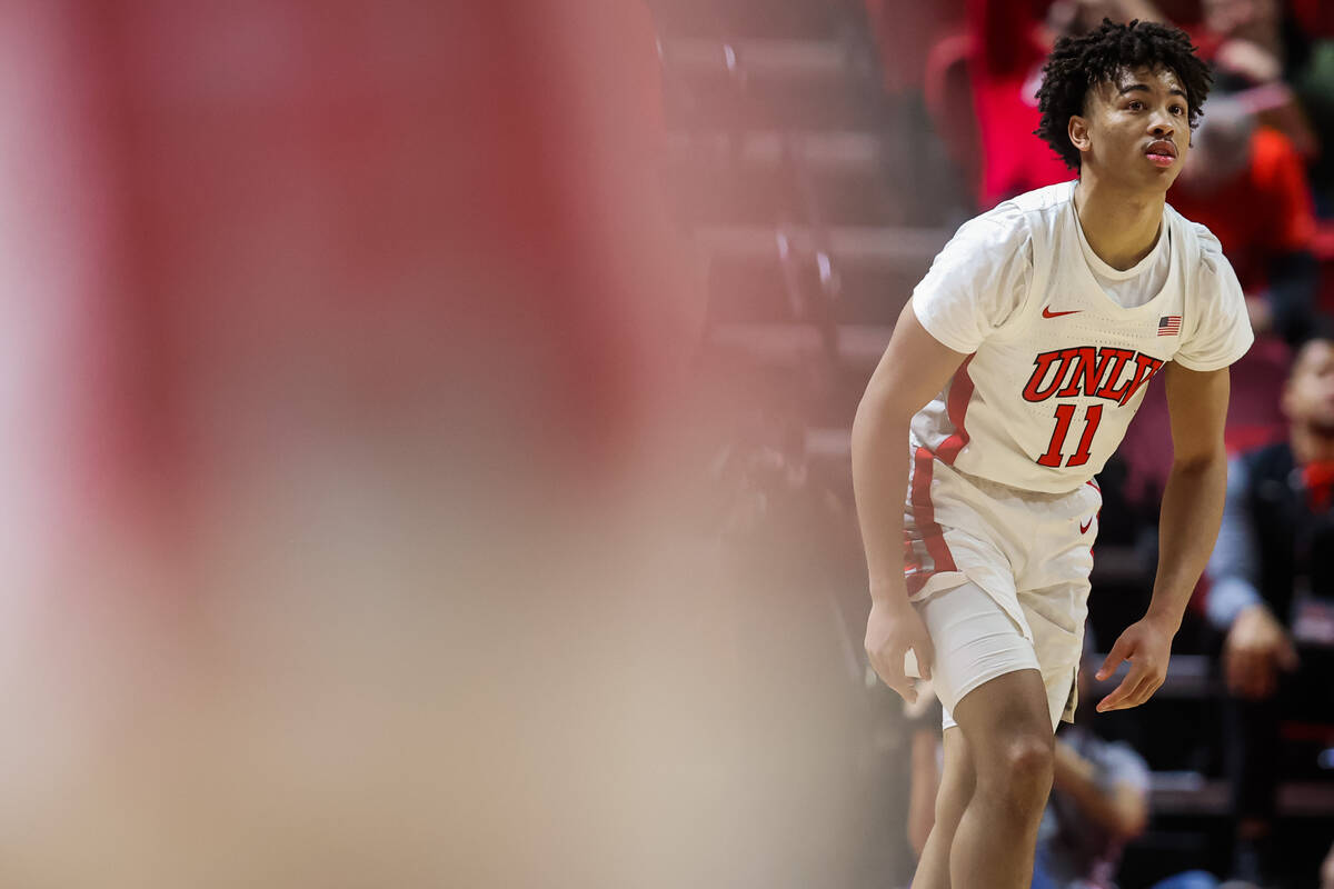 Rebels guard Dedan Thomas Jr. (11) watches for the ball during an NCAA basketball game between ...