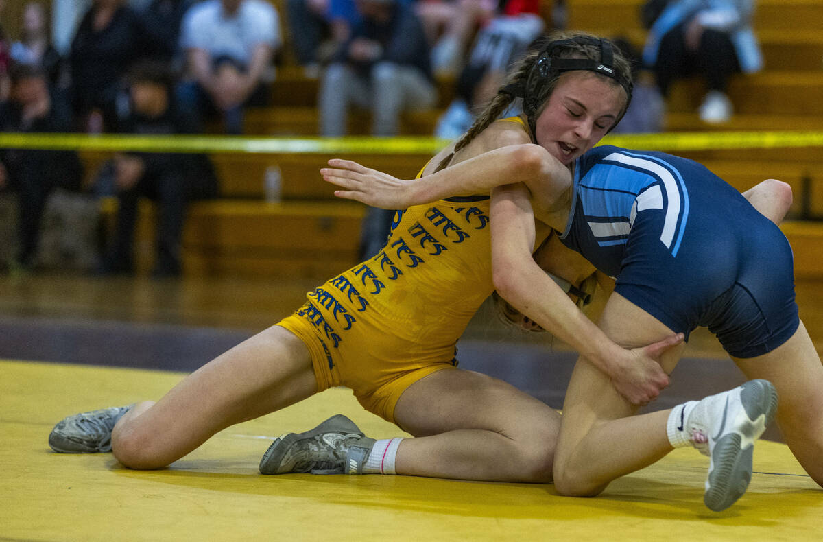 Moapa Valley’s Anna Winward grabs the leg of Centennial’s Kaydyn Brooks during th ...