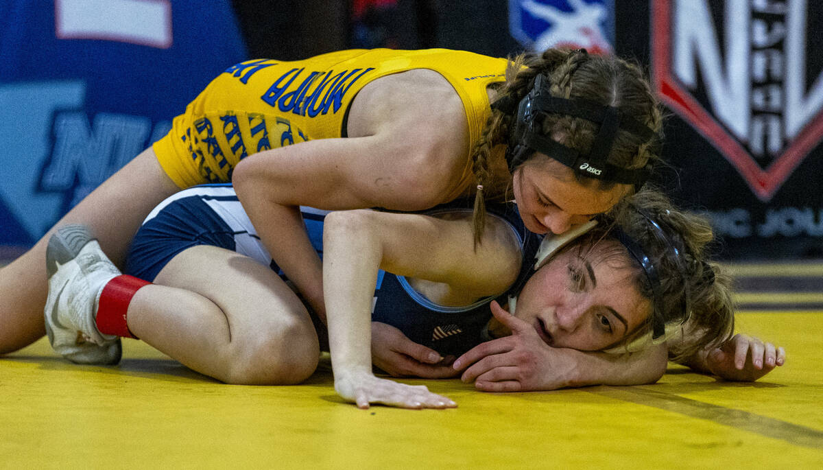 Moapa Valley’s Anna Winward pushes Centennial’s Kaydyn Brooks down to the mat dur ...