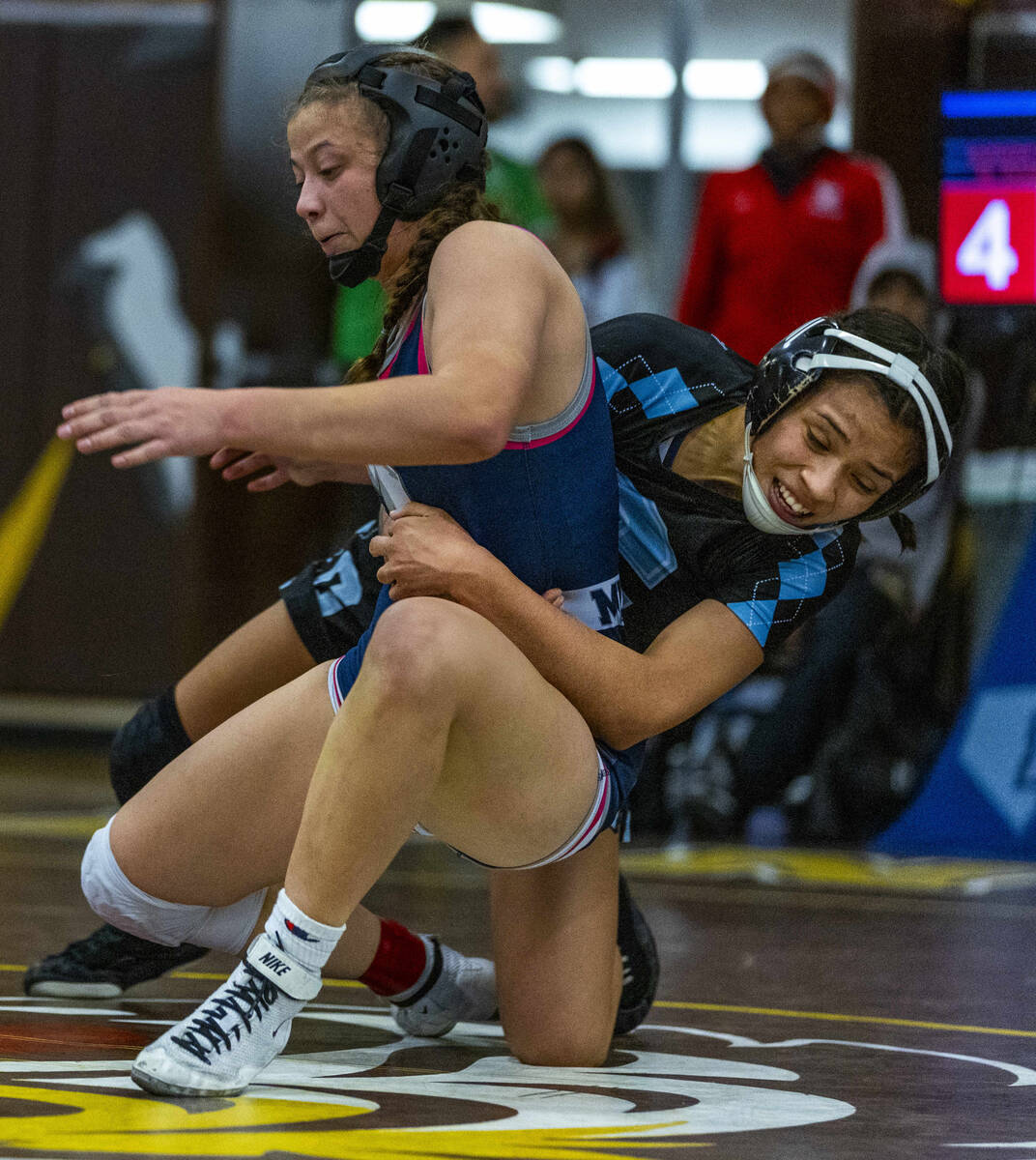 Shadow Ridge’s Makayla Power is pulled down by Centennial’s Mya Bardoni during th ...