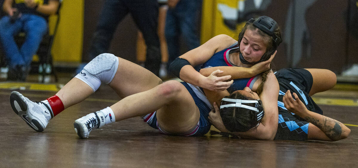 Shadow Ridge’s Makayla Power gets atop of Centennial’s Mya Bardoni for a pin duri ...