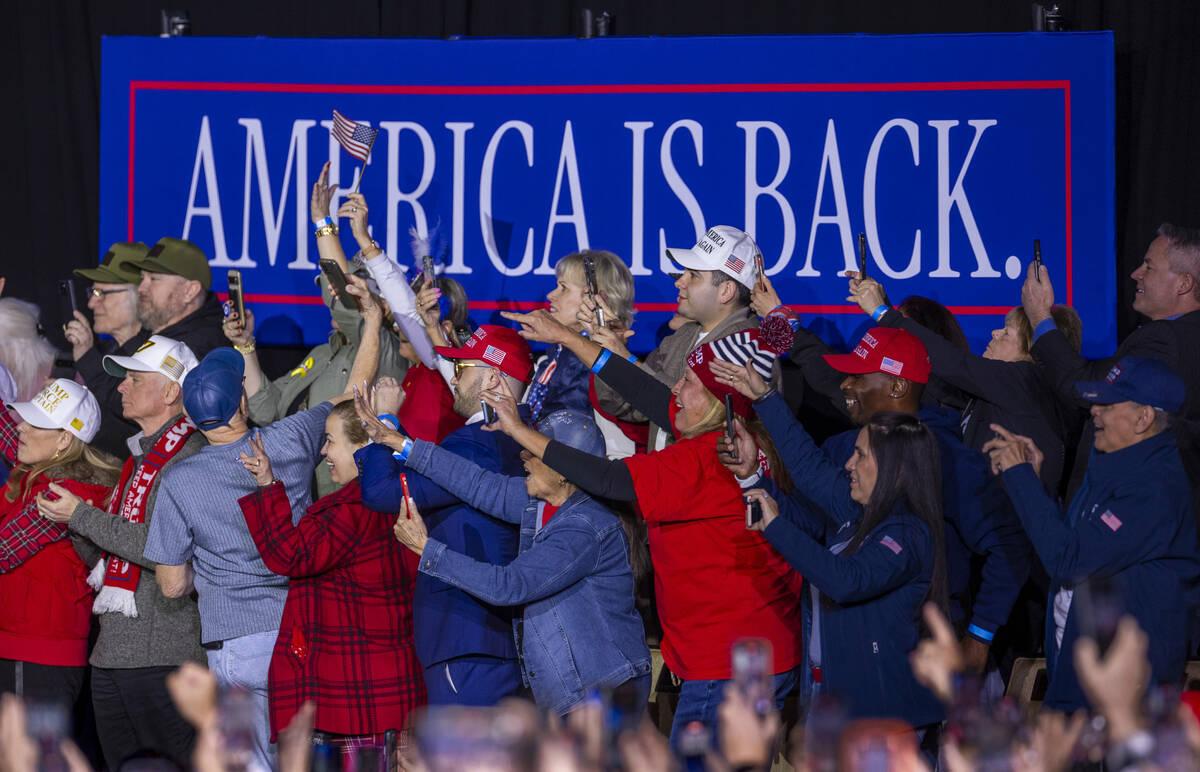 Phones are raised to take photos and videos as President Donald Trump arrives to speak to suppo ...