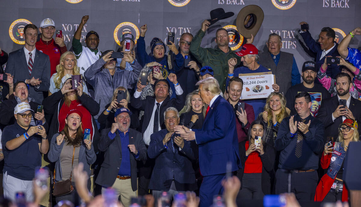 President Donald Trump dances with supporters after a speech at the Circa on Saturday, Jan. 25, ...