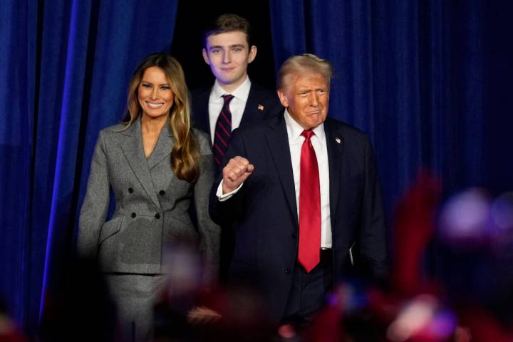 President Donald Trump, joined by Melania Trump, left, and Barron Trump, arrives to speak at an ...