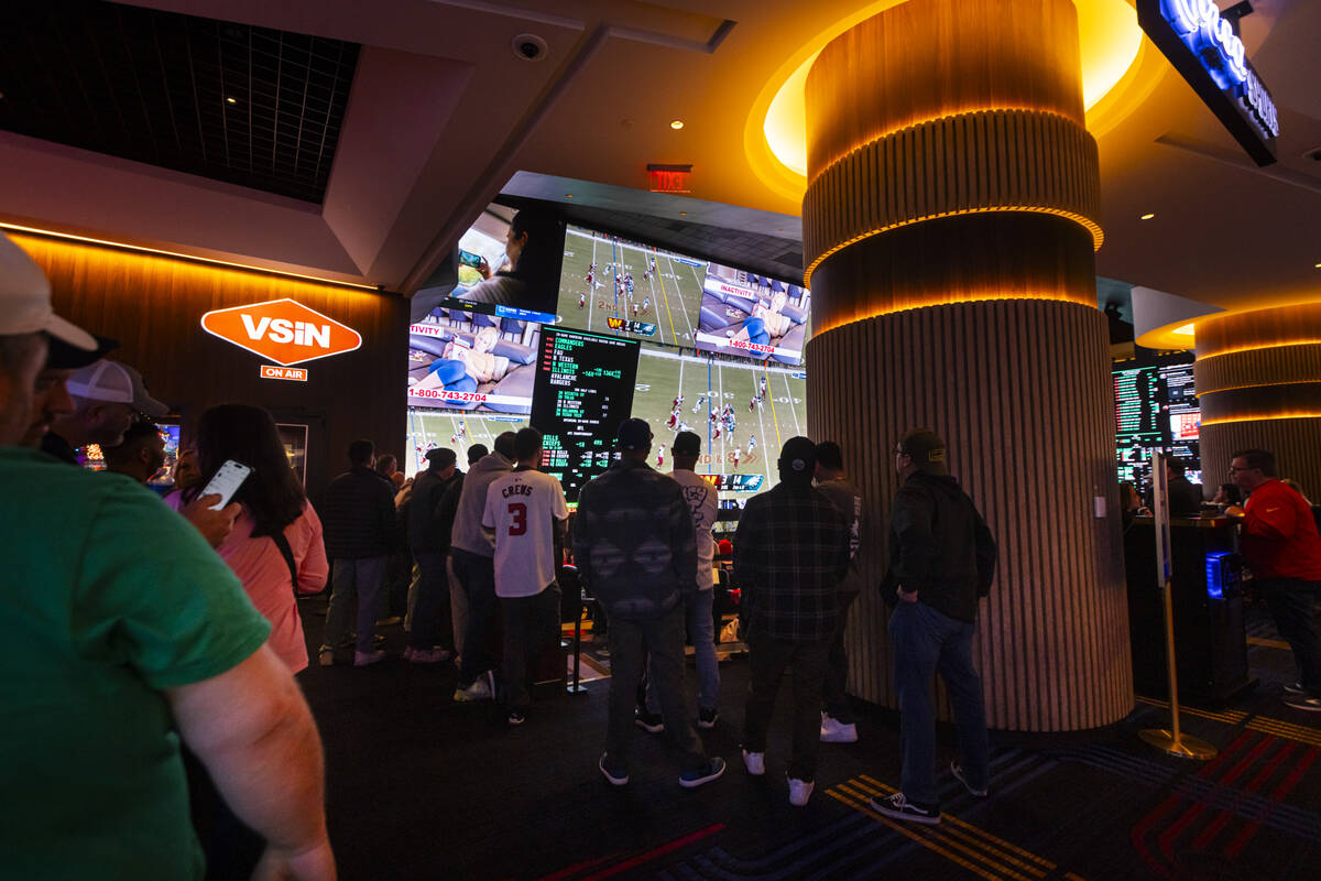 People gather around the casino to watch the NFC championship football game between the Philade ...