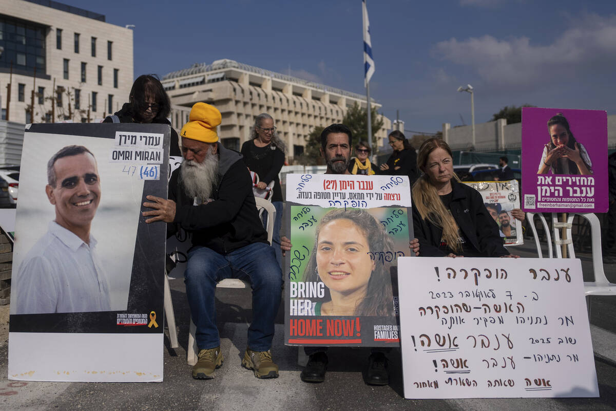 Families and supporters of Israeli hostages held by Hamas in Gaza, hold photos of their loved o ...