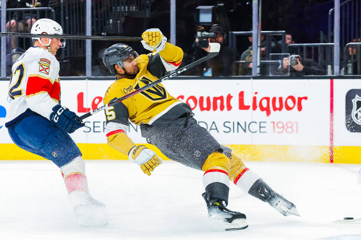 Golden Knights right wing Keegan Kolesar (55) falls in a race for the puck during an NHL hockey ...