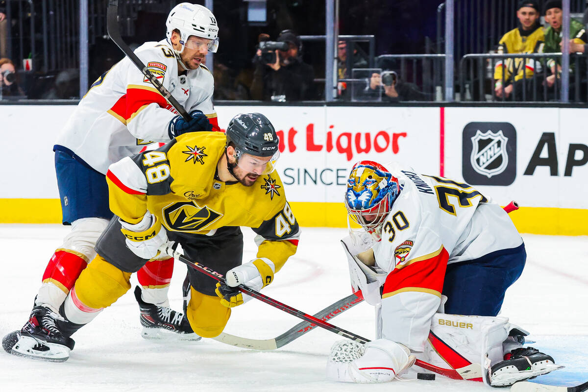 Golden Knights center Tomas Hertl (48) tries to move in on the puck while Florida Panthers goal ...