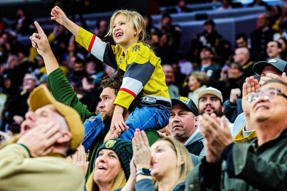 A young Golden Knights fan cheers as her team makes their second goal of the night during an NH ...