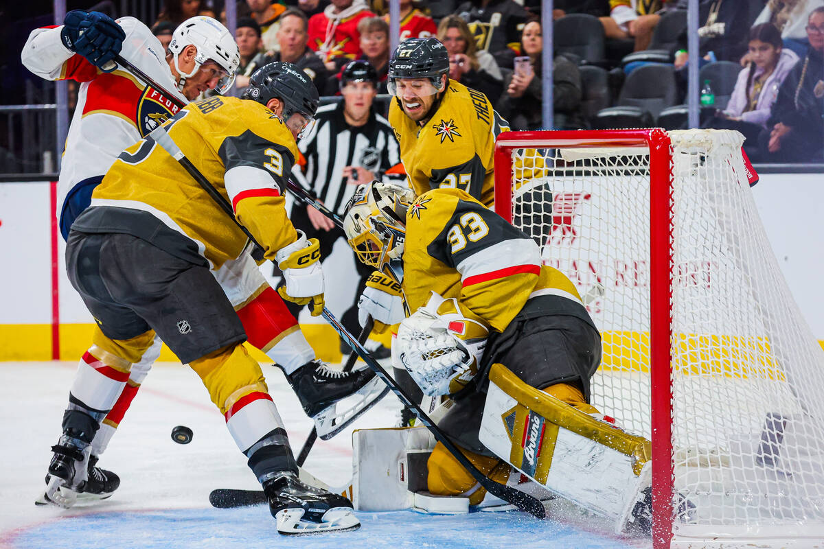 Golden Knights goaltender Adin Hill (33) works for a save as the puck comes close during an NHL ...