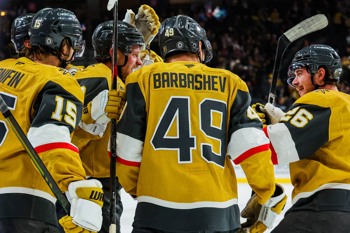 Golden Knights center Jack Eichel (center) celebrates his goal with his teammates during an NHL ...