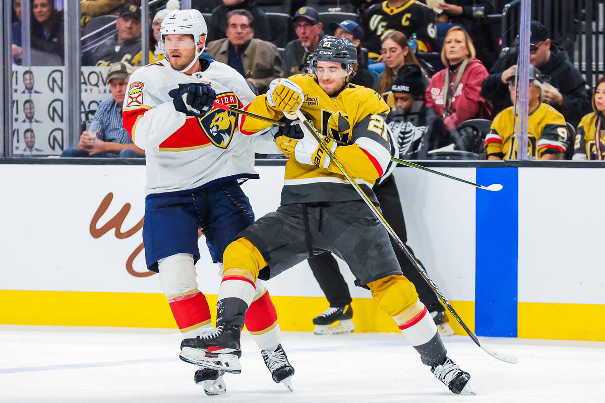 Golden Knights center Brett Howden (21) pushes against Florida Panthers defenseman Dmitry Kulik ...