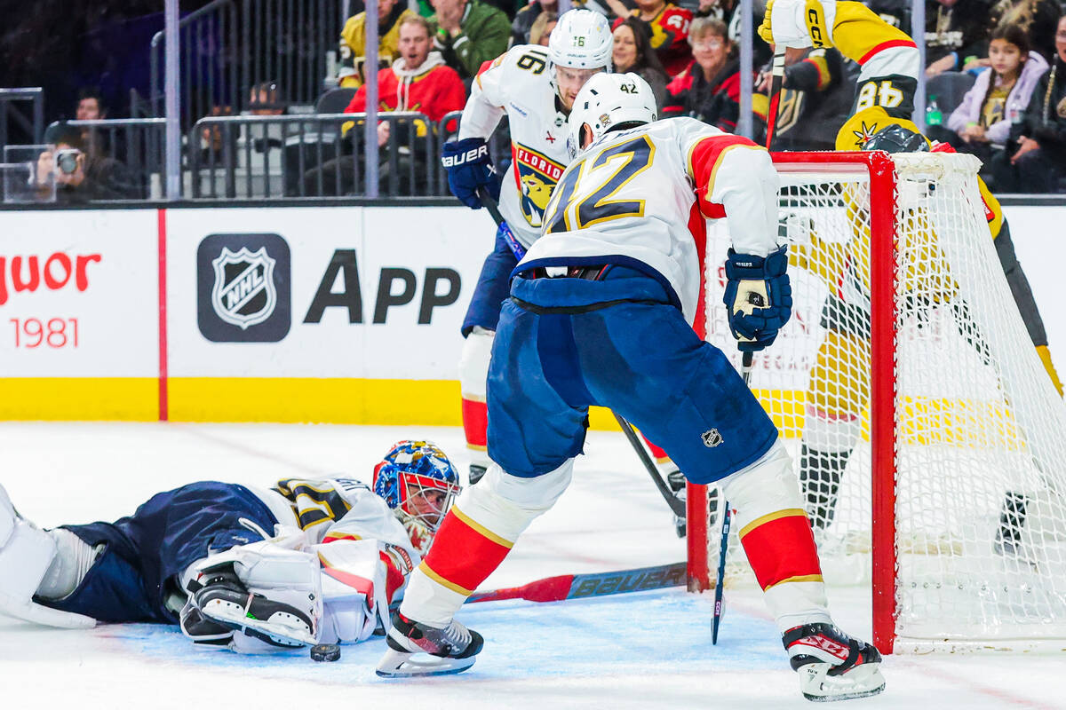 Florida Panthers goaltender Spencer Knight (30) eyes the puck as it comes close to the net duri ...