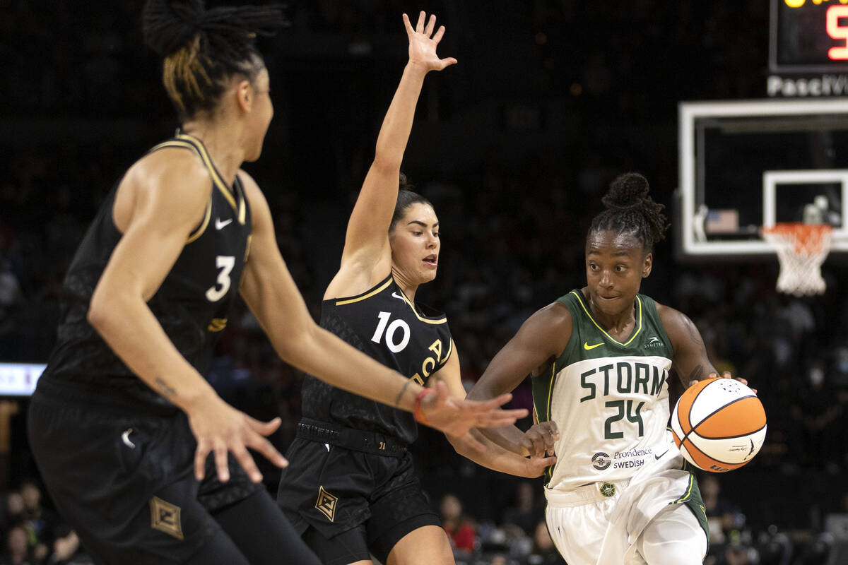 Seattle Storm guard Jewell Loyd (24) dribbles around Las Vegas Aces guard Kelsey Plum (10) whil ...