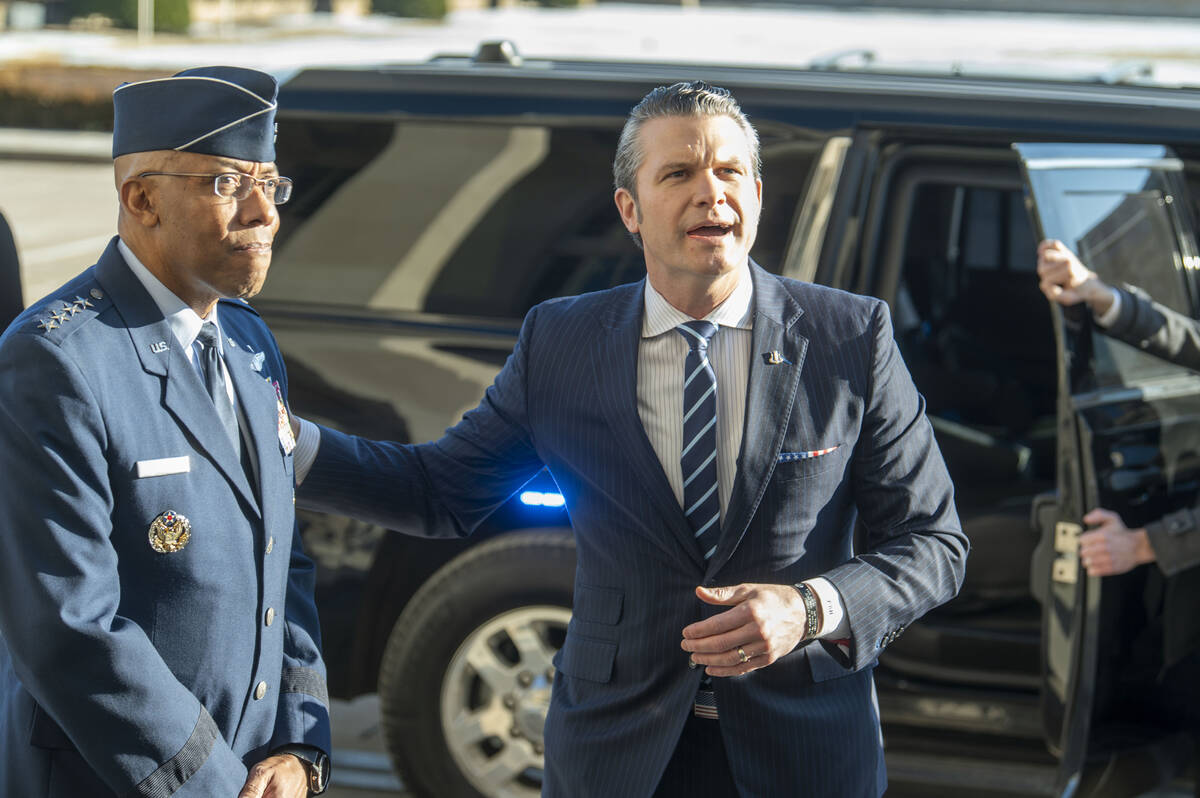 Defense Secretary Pete Hegseth, right, pats Chairman of the Joint Chiefs of Staff Gen. Charles ...